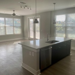 Live at Cadence music Factory  Open-concept kitchen and living area at  Cadence Music Factory apartments in Uptown Charlotte.