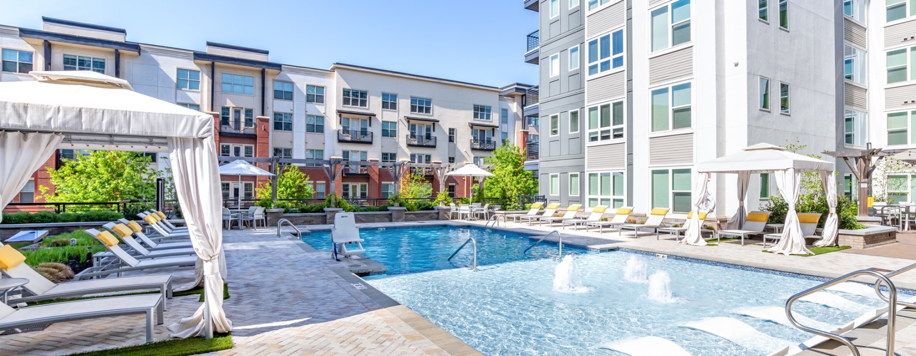 pool with lounge seating and cabanas